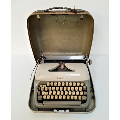 277 - ADLER JUNIOR E TRAVELLING TYPEWRITER
with a Qwerty keyboard and hard shell case