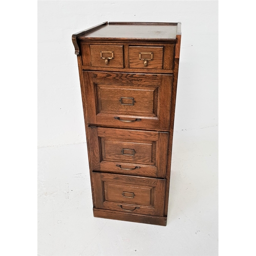 486 - OAK FILING CABINET
with a moulded top above two short index card drawers with three panelled drawers... 