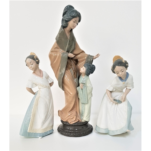 249 - THREE NAO FIGURINES
depicting a Japanese mother and her daughter, 38cm high, and two young girls, 24... 