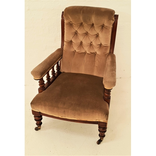 457 - VICTORIAN ARMCHAIR
with a mahogany frame and a button back above padded arms with turned supports be... 