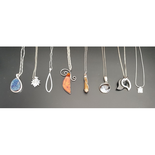 30 - EIGHT SILVER AND SILVER MOUNTED PENDANTS
including amber and agate set examples and an opal set pend... 