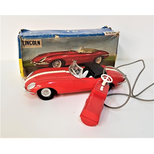 247 - E TYPE JAGUAR MODEL CAR
by Lincoln International with remote control and power steering, in red plas... 