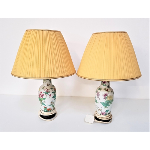 327 - PAIR OF HEREND PORCELAIN TABLE LAMPS
decorated with flowers and butterflies, both with pleated yello... 