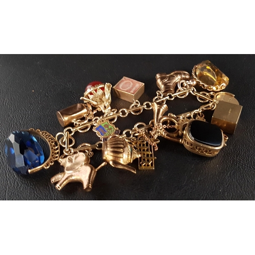 13 - NINE CARAT GOLD CHARM BRACELET
the charms including three swivel fobs, one with green and black agat... 