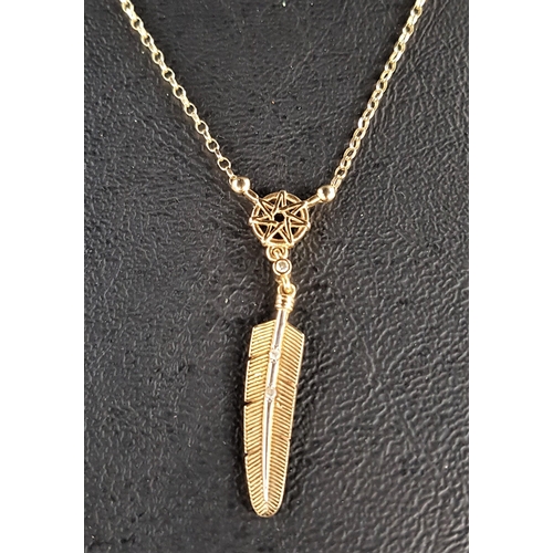 73 - NINE CARAT GOLD FEATHER PENDANT
the feather drop below a small diamond and pierced star motif, on at... 