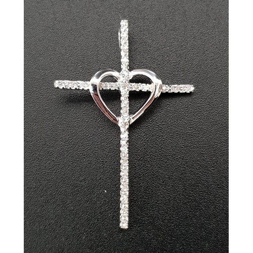 9 - DIAMOND SET CROSS PENDANT
with central heart detail, in unmarked white gold, 3.2cm high