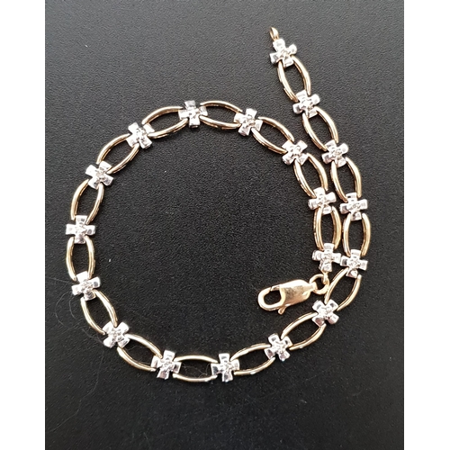 15 - DIAMOND SET NINE CARAT GOLD BRACELET
with alternating diamond set cross shaped links and pierced ova... 