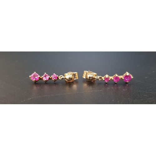 16 - PAIR OF RUBY DROP EARRINGS
each earring set with three graduated rubies, in nine carat gold