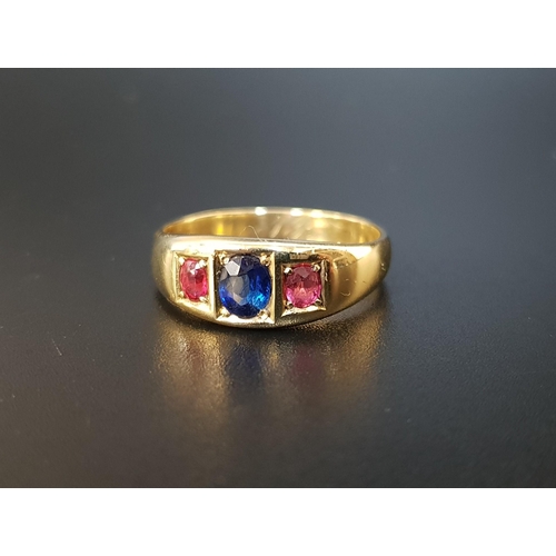32 - SAPPHIRE AND RUBY THREE STONE RING
the central oval cut sapphire approximately 0.5cts flanked by sma... 
