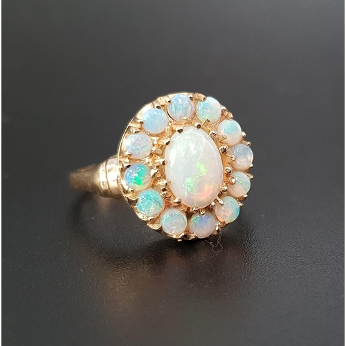 81 - OPAL CLUSTER RING
the central oval cabochon opal in twelve opal surround, on nine carat gold shank, ... 