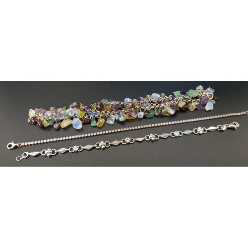 88 - COLOURFUL MULTI STRAND STONE SET BRACELET
in silver; together with a CZ set silver line bracelet and... 