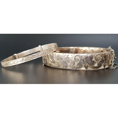 91 - SCROLL ENGRAVED SILVER BANGLE
with safety chain, London hallmarks for 1964; together with a silver C... 