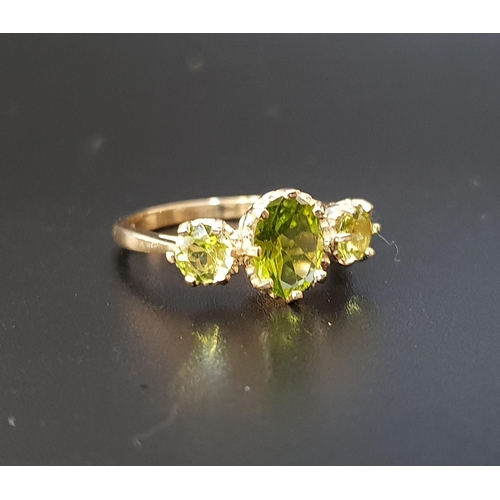 105 - PERIDOT THREE STONE RING
the central oval cut peridot approximately 1ct flanked by a round cut perid... 