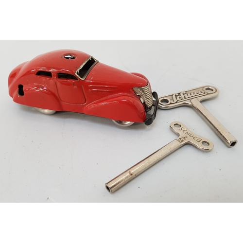 243 - VINTAGE SCHUCO 3000 TINPLATE CAR
in red livery with two branded wind up keys