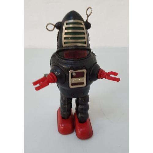 249 - TINPLATE ROBBIE THE ROBOT
with a clockwork mechanism by KO of Japan, with a black body, red feet and... 