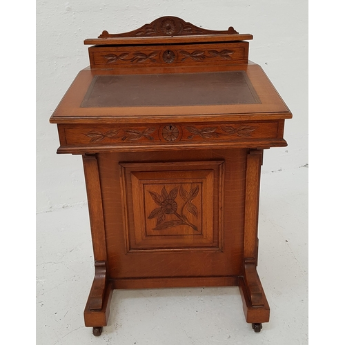 324 - EDWARDIAN OAK DAVENPORT
with a shaped and carved top above a fitted stationary box, the lift up slop... 