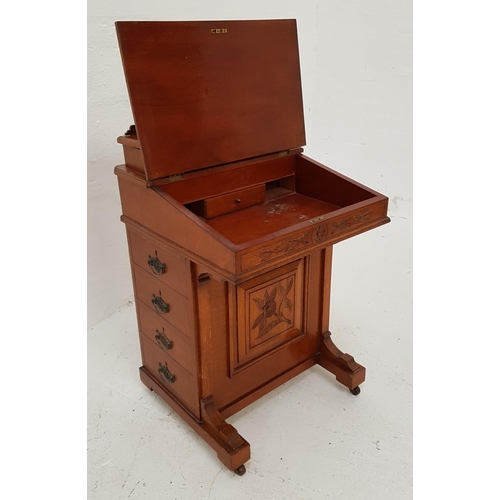 324 - EDWARDIAN OAK DAVENPORT
with a shaped and carved top above a fitted stationary box, the lift up slop... 