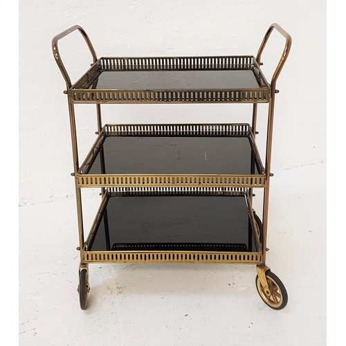 343 - GILT METAL HOSTESS TROLLEY
with three smoked glass shelves with pierced galleries and shaped handles... 