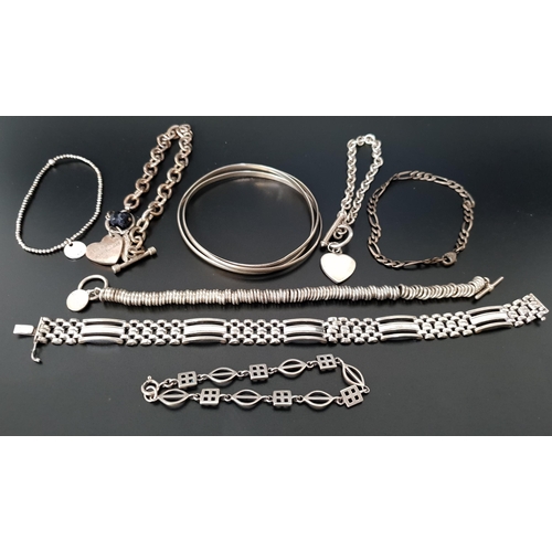 7 - SELECTION OF EIGHT SILVER BRACELETS AND BANGLES
including a triple entwined Russian wedding ring des... 
