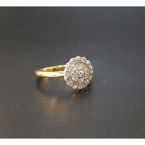 69 - DIAMOND CLUSTER RING
the central diamond surrounded by two rows of diamonds, on eighteen carat gold ... 