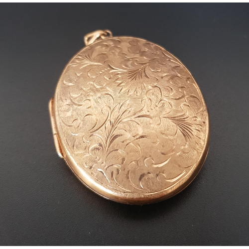 128 - LARGE NINE CARAT GOLD LOCKET PENDANT
the oval locket with engraved scroll and floral decoration, 5.5... 