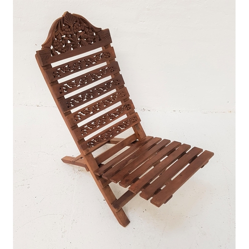 371 - TEAK TWO PIECE CARVED LOW CHAIR
with a slatted back carved with vines above a slatted seat