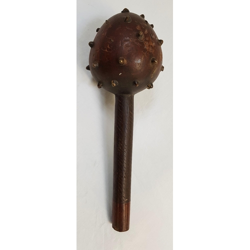 172 - HARDWOOD MACE
the bulbous head with brass studs, the handle with sinuous carved decoration, 36cm lon... 