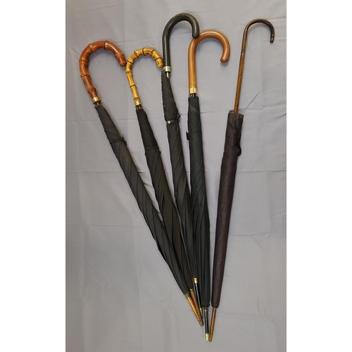 175 - FOUR GENTLEMANS BLACK UMBRELLAS
one with a gold plated collar and one with a rolled gold collar, tog... 