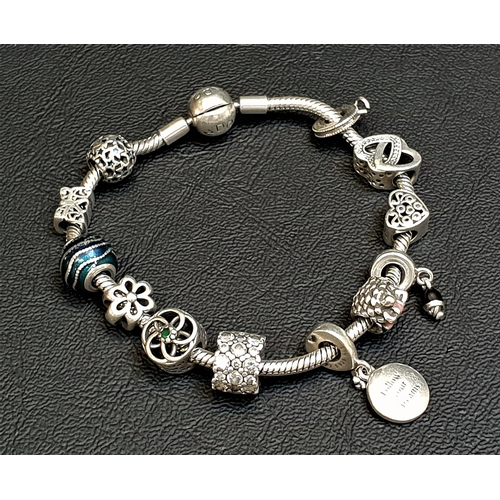 98 - PANDORA MOMENTS SMOOTH SILVER CLASP CHARM BRACELET
with a selection of Pandora and other charms, inc... 