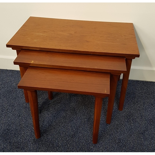 430 - NEST OF TEAK TABLES
with rectangular tops, standing on tapering supports, 39cm high