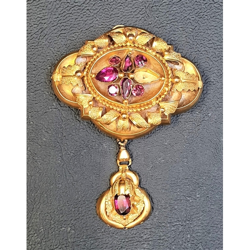 70 - VICTORIAN UNMARKED HIGH CARAT GOLD BROOCH/PENDANT
the ornate relief scroll decorated brooch with cen... 