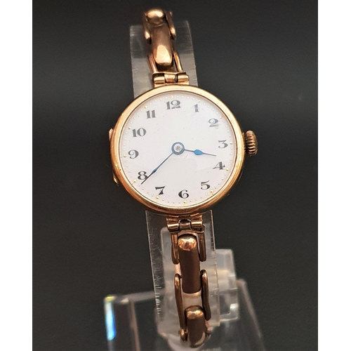 63 - LADIES NINE CART GOLD CASED WRISTWATCH
the white dial with black Arabic numerals and gilt highlights... 