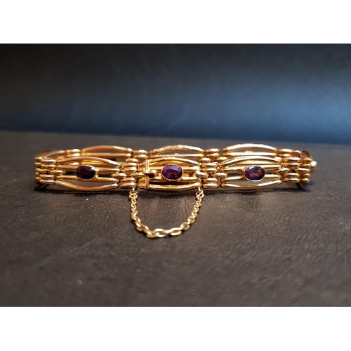 89 - AMETHYST SET NINE CARAT GOLD BRACELET
the gate style bracelet with eight bezel set amethysts, with s... 