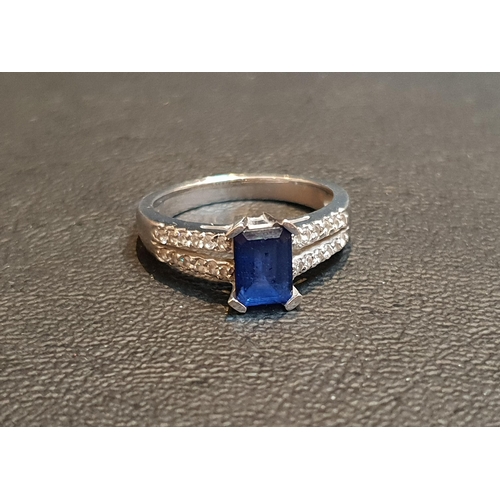 106 - SAPPHIRE AND DIAMOND RING
the emerald cut sapphire approximately 1.2cts flanked by diamonds to the d... 