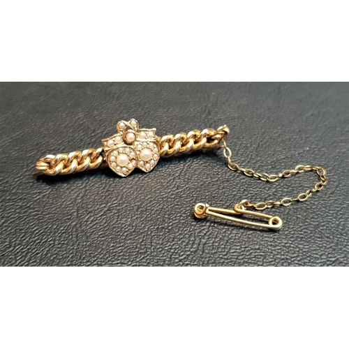 112 - SEED PEARL SET NINE CARAT GOLD BAR BROOCH
the pearls set to the central double heart and bow motif, ... 