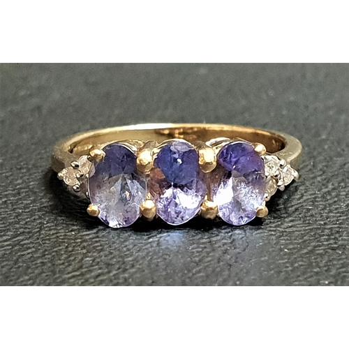 94 - TANZANITE AND DIAMOND RING
the three oval cut tanzanites flanked by three small diamonds to each sho... 