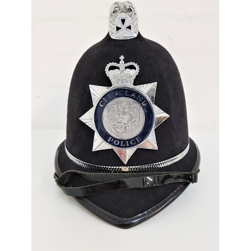 256 - POLICE HELMET
with the Cleveland Police force badge, with chin strap and named to PC Doherty