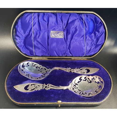 128 - PAIR OF EDWARD VII BERRY SPOONS
with pierced bowls and handles, in a fitted case marked James Cricht... 