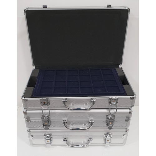 314 - THREE ALUMINIUM COIN CASES
two containing four removable trays and one with six trays, all with keys