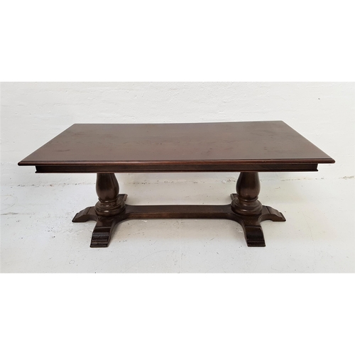 386 - DARK OAK OCCASIONAL TABLE
with an oblong moulded top, standing on a pair of bulbous supports with fl... 