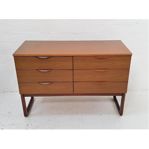 393 - EUROPA TEAK CHEST
with an arrangement of six short drawers with roll over handles, standing on shape... 