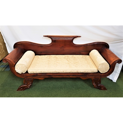 406 - EMPIRE STYLE TEAK SOFA
with a shaped back and scroll arms, standing on carved shaped supports, with ... 