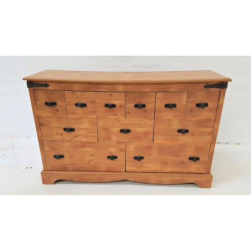 421 - PINE EFFECT CHEST
with a moulded top above an arrangement of eleven drawers, standing on bracket fee... 