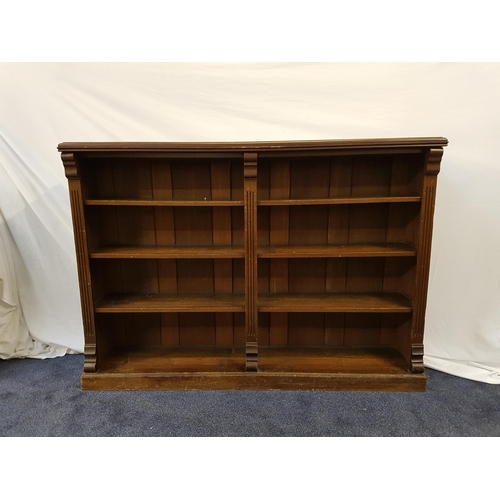 374 - STAINED PINE BOOKCASE
with a moulded top above four open front shelves, standing on a plinth base, 1... 