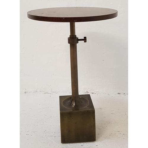 436 - WALNUT OCCASIONAL TABLE
with a segmented oval top raised on a square metal base and tubular column, ... 