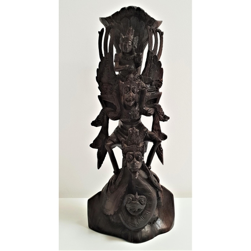 177 - BALINESE TEAK CARVING
depicting the bird god Garuda and other deities and mythical beasts, 32cm high