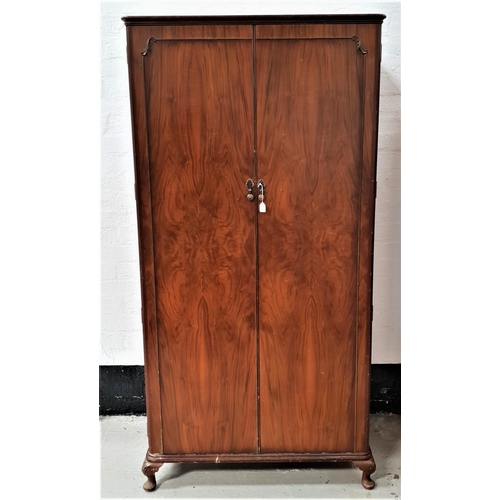 347 - WALNUT WARDROBE
with a pair of panelled doors opening to reveal hanging space, four shelves and a dr... 