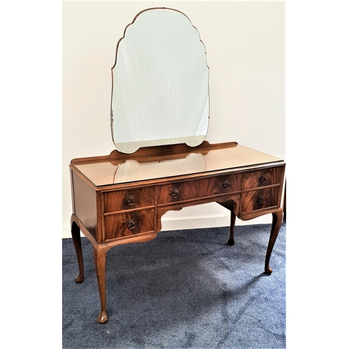 350 - MAHOGANY KNEEHOLE DRESSING TABLE
with a shaped mirror back above an arrangement of five drawers, sta... 