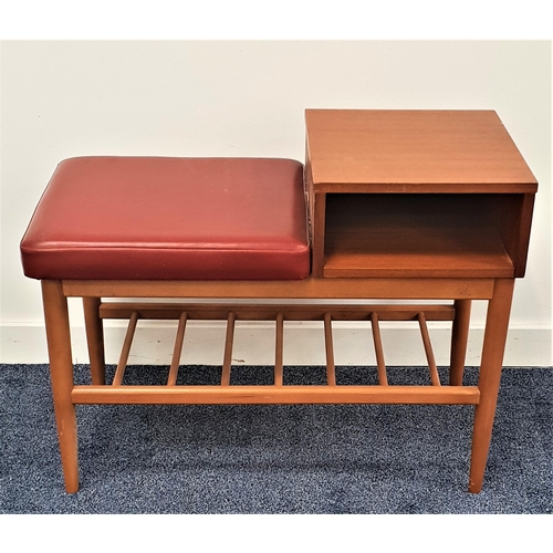 357 - 1950s TEAK AND BEECH TELEPHONE TABLE
with a red vinyl covered seat next to a teak shelf with a compa... 