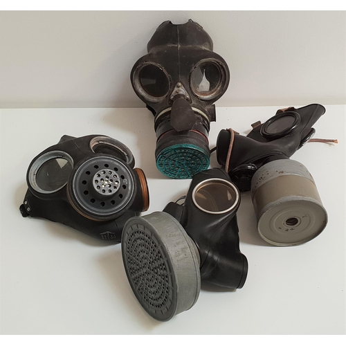 325 - FOUR GAS MASKS
from the WWII era, all with rubber face coverings, adjustable fittings and filters (4... 